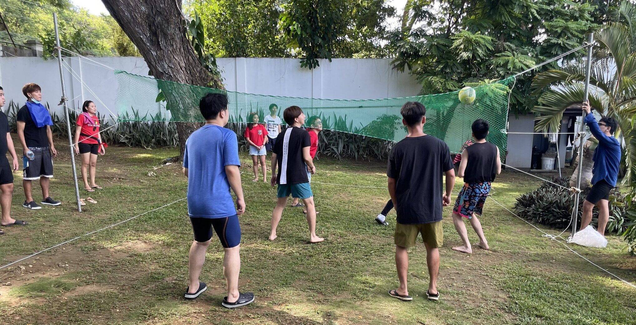 Members playing volleyball during team building